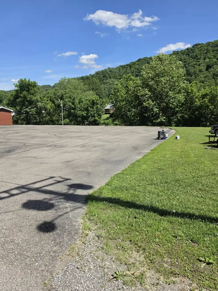 Faded gray lot by a white fence