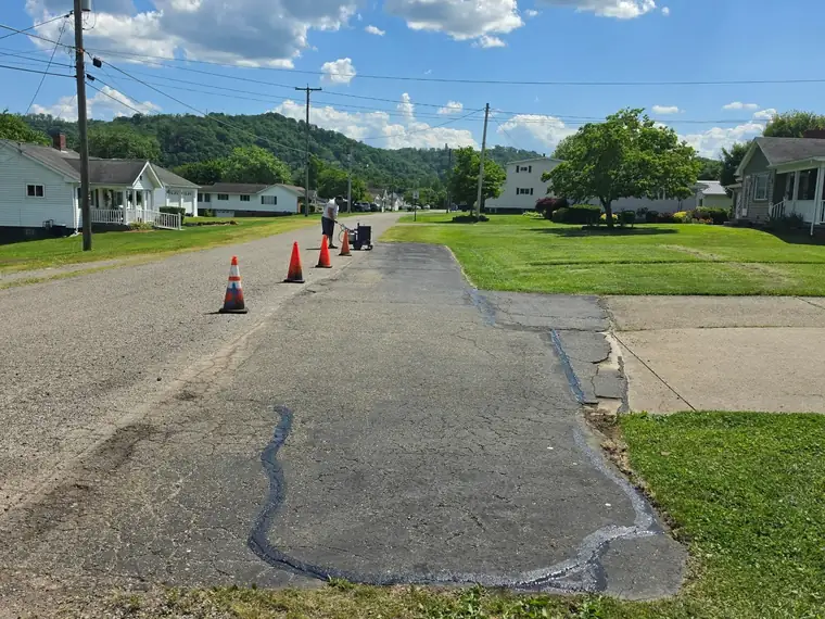 Worn driveway apron at the street