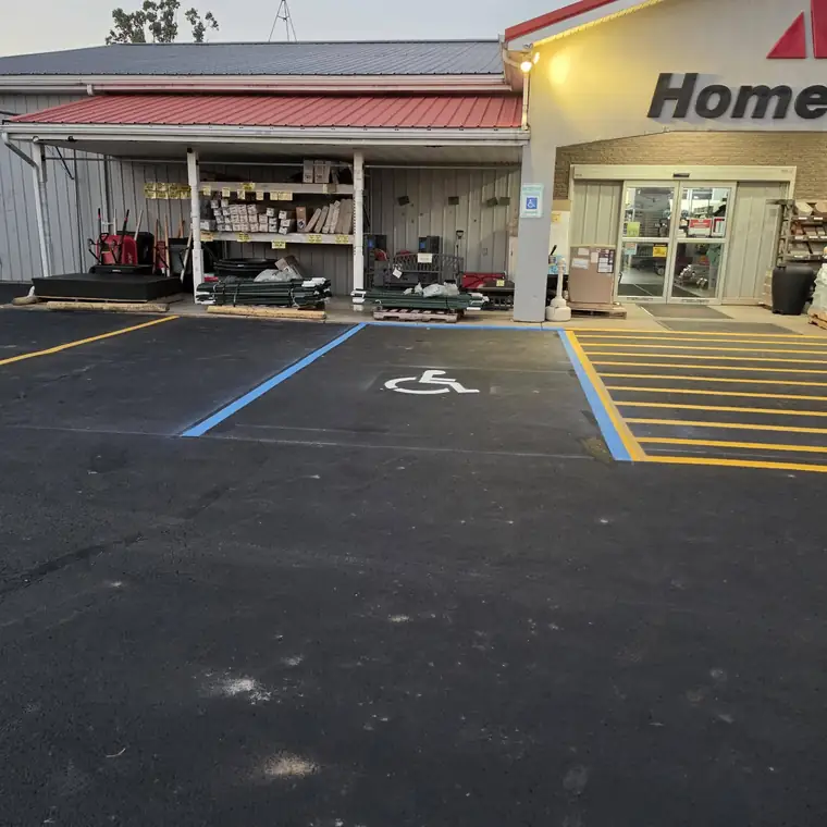 Store entrance with new ADA van-accessible stall in blue and yellow hatched aisle