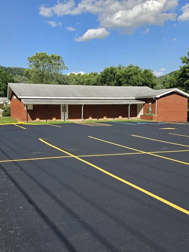 Commercial lot with new yellow stalls by a brick building