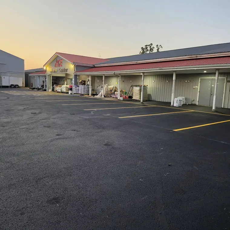 Store parking lot sealcoated with new yellow stall lines, Ohio Valley
