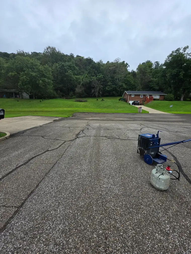 Driveway after hot crack filling with the melter still on site, Ohio Valley