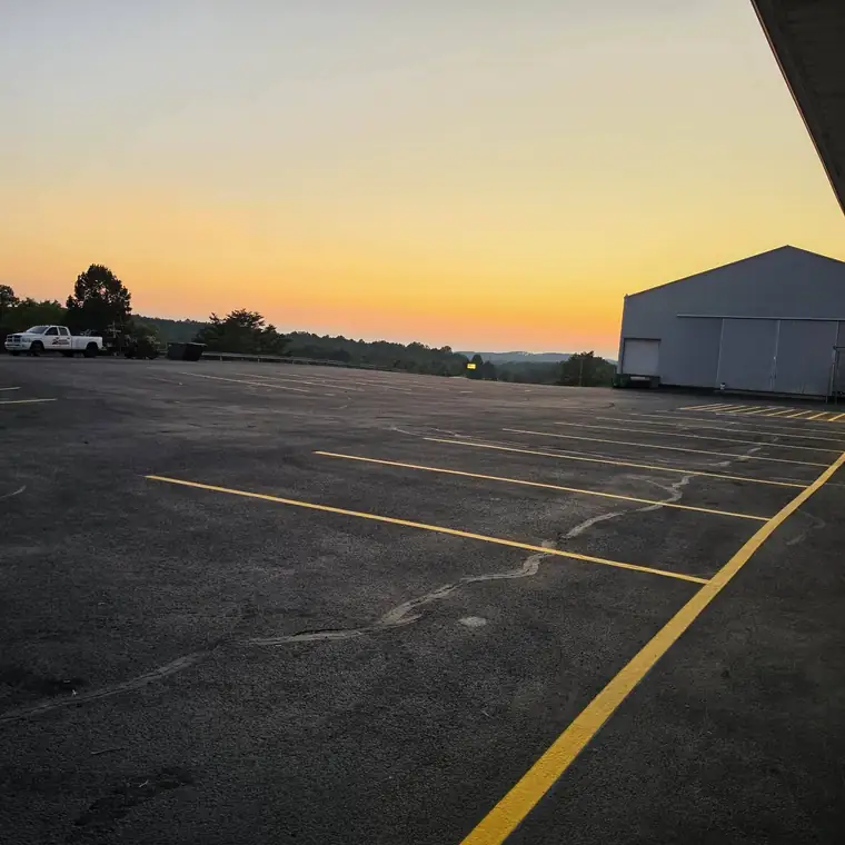 Fresh yellow stall lines on new sealcoat