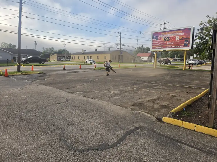 Convenience store parking lot blown clean and ready for sealing